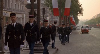 Movie still from “The Day of the Jackal” (1973), directed by Fred Zinnemann – A group of men walking down the street in uniform; Wide shot, High angle