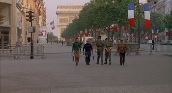 Movie still from “The Day of the Jackal” (1973), directed by Fred Zinnemann – A group of people walking down a street; Wide shot, High angle