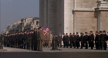 Movie still from “The Day of the Jackal” (1973), directed by Fred Zinnemann – A group of men standing next to each other on a street; Extreme Wide shot, Low angle