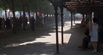Movie still from “The Day of the Jackal” (1973), directed by Fred Zinnemann – A group of people standing in a line under an awning; Extreme Wide shot, High angle