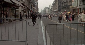Movie still from “The Day of the Jackal” (1973), directed by Fred Zinnemann – A group of people walking down a street; Extreme Wide shot, High angle