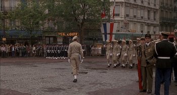 Movie still from “The Day of the Jackal” (1973), directed by Fred Zinnemann – A group of men in uniform marching down a street; Wide shot, High angle
