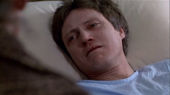 Movie still from “The Dead Zone” (1983), directed by David Cronenberg – A person laying in a hospital bed; Close Up shot, High angle
