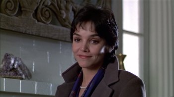 Movie still from “The Dead Zone” (1983), directed by David Cronenberg – A person wearing a suit and a necklace; Close Up shot, Low angle