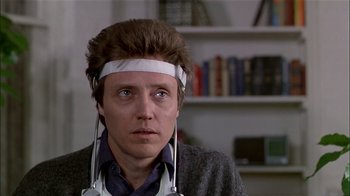 Movie still from “The Dead Zone” (1983), directed by David Cronenberg – A man with a head band and ear phones on his head; Close Up shot, Low angle