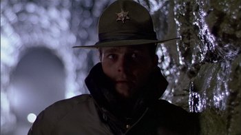 Movie still from “The Dead Zone” (1983), directed by David Cronenberg – A man wearing a hat and a jacket; Close Up shot, Low angle