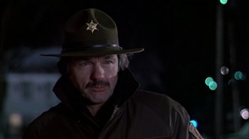 Movie still from “The Dead Zone” (1983), directed by David Cronenberg – A man wearing a hat and a uniform; Close Up shot, Low angle