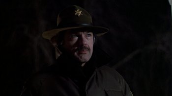 Movie still from “The Dead Zone” (1983), directed by David Cronenberg – A man wearing a hat with a star on it; Close Up shot, Low angle