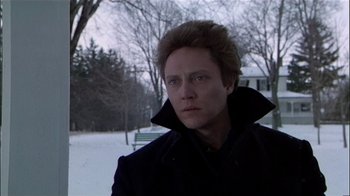 Movie still from “The Dead Zone” (1983), directed by David Cronenberg – A man in a black coat standing in the snow; Close Up shot, Low angle