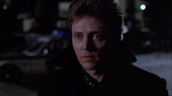 Movie still from “The Dead Zone” (1983), directed by David Cronenberg – A person wearing a suit and tie; Close Up shot, Low angle
