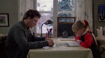 Movie still from “The Dead Zone” (1983), directed by David Cronenberg – A man sitting at a table writing on a piece of paper next to a girl; Medium shot, Over the shoulder angle
