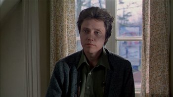 Movie still from “The Dead Zone” (1983), directed by David Cronenberg – A person standing in front of a window; Close Up shot, Over the shoulder angle