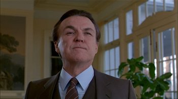 Movie still from “The Dead Zone” (1983), directed by David Cronenberg – A person wearing a suit and tie; Close Up shot, Low angle