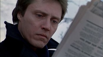 Movie still from “The Dead Zone” (1983), directed by David Cronenberg – A person reading a newspaper; Close Up shot, Low angle