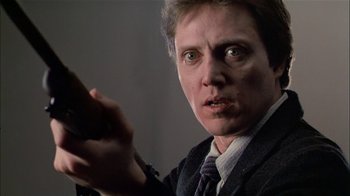 Movie still from “The Dead Zone” (1983), directed by David Cronenberg – A person wearing a suit and tie; Close Up shot, Low angle