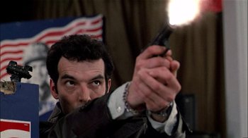 Movie still from “The Dead Zone” (1983), directed by David Cronenberg – A man holding a gun in his hand; Close Up shot, Low angle