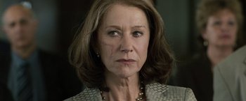 Movie still from “The Debt” (2010), directed by John Madden – An older woman wearing a necklace and looking at the camera; Close Up shot, Low angle