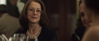 Movie still from “The Debt” (2010), directed by John Madden – An older woman wearing glasses and a black dress; Close Up shot, Over the shoulder angle