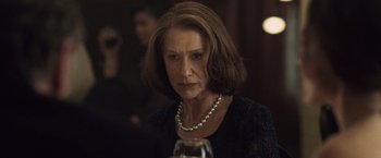 Movie still from “The Debt” (2010), directed by John Madden – A person wearing a necklace; Close Up shot, Over the shoulder angle