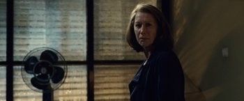 Movie still from “The Debt” (2010), directed by John Madden – A woman standing in front of a window; Close Up shot, Low angle