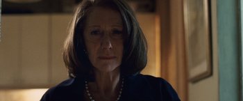 Movie still from “The Debt” (2010), directed by John Madden – A person wearing a necklace; Close Up shot, Low angle