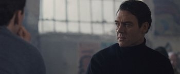 Movie still from “The Debt” (2010), directed by John Madden – A person wearing a black shirt; Close Up shot, Low angle