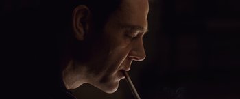 Movie still from “The Debt” (2010), directed by John Madden – A person with a cigarette in his mouth; Close Up shot, Low angle