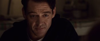 Movie still from “The Debt” (2010), directed by John Madden – A man's face in the dark; Close Up shot, Over the shoulder angle