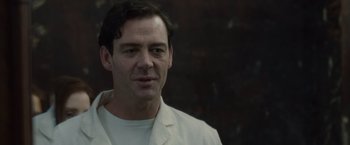 Movie still from “The Debt” (2010), directed by John Madden – A person wearing a white jacket; Close Up shot, Low angle