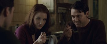Movie still from “The Debt” (2010), directed by John Madden – A man and a woman eating food together; Close Up shot, Over the shoulder angle