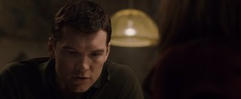 Movie still from “The Debt” (2010), directed by John Madden – A person sitting in front of a lamp; Close Up shot, Over the shoulder angle