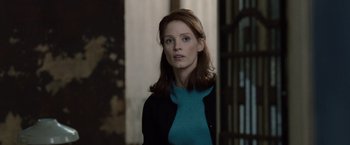 Movie still from “The Debt” (2010), directed by John Madden – A woman with long hair wearing a blue sweater; Medium shot, Over the shoulder angle