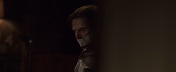 Movie still from “The Debt” (2010), directed by John Madden – A man with duct tape around his mouth; Close Up shot, Over the shoulder angle