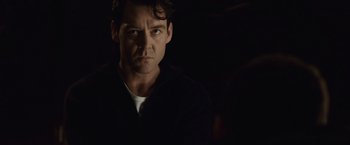 Movie still from “The Debt” (2010), directed by John Madden – A person in a dark room; Close Up shot, Over the shoulder angle