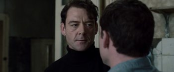 Movie still from “The Debt” (2010), directed by John Madden – A person looking at a person in a mirror; Close Up shot, Over the shoulder angle