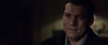 Movie still from “The Debt” (2010), directed by John Madden – A man's face in a dark room; Close Up shot, Over the shoulder angle