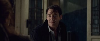 Movie still from “The Debt” (2010), directed by John Madden – A person wearing a jacket; Close Up shot, Over the shoulder angle