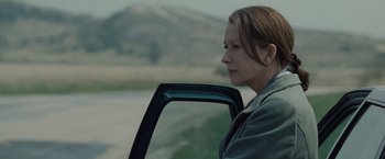 Movie still from “The Debt” (2010), directed by John Madden – A woman sitting in the back seat of a car; Close Up shot, Low angle