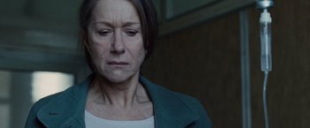 Movie still from “The Debt” (2010), directed by John Madden – An older woman is looking down at her face; Close Up shot, Low angle