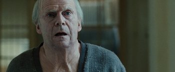 Movie still from “The Debt” (2010), directed by John Madden – An old man with a surprised look on his face; Close Up shot, Low angle