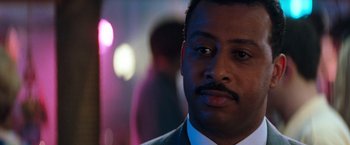 Movie still from “The Devil's Advocate” (1997), directed by Taylor Hackford – A person wearing a suit and tie; Close Up shot, Low angle