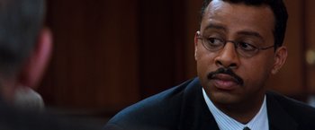 Movie still from “The Devil's Advocate” (1997), directed by Taylor Hackford – A man in a suit and tie; Close Up shot, Over the shoulder angle