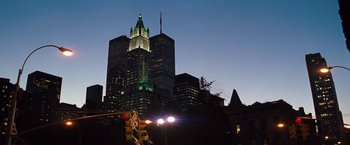 Movie still from “The Devil's Advocate” (1997), directed by Taylor Hackford – A view of a city skyline at night with a traffic light; Extreme Wide shot, Low angle