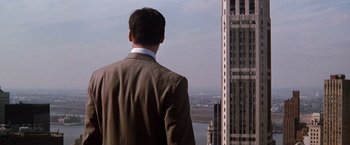 Movie still from “The Devil's Advocate” (1997), directed by Taylor Hackford – A man in a suit looking out over a city; Extreme Wide shot, Over the shoulder angle