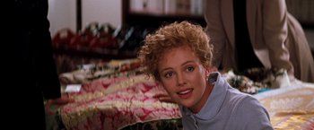 Movie still from “The Devil's Advocate” (1997), directed by Taylor Hackford – A person with curly blonde hair; Close Up shot, Over the shoulder angle