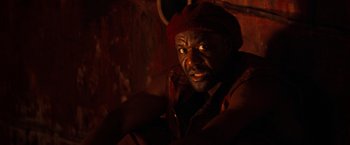 Movie still from “The Devil's Advocate” (1997), directed by Taylor Hackford – A man with a red hat is looking at the camera; Close Up shot, High angle