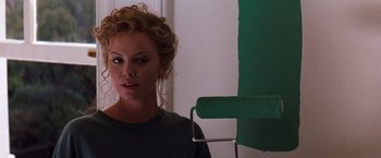 Movie still from “The Devil's Advocate” (1997), directed by Taylor Hackford – A woman standing in front of a wall with a paint roller; Close Up shot, Over the shoulder angle