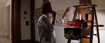 Movie still from “The Devil's Advocate” (1997), directed by Taylor Hackford – A man standing in a room brushing his teeth; Medium shot, Low angle