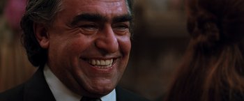 Movie still from “The Devil's Advocate” (1997), directed by Taylor Hackford – An older man smiling with his mouth wide open; Close Up shot, Low angle