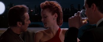 Movie still from “The Devil's Advocate” (1997), directed by Taylor Hackford – A woman in a red dress is looking to her left; Close Up shot, Over the shoulder angle